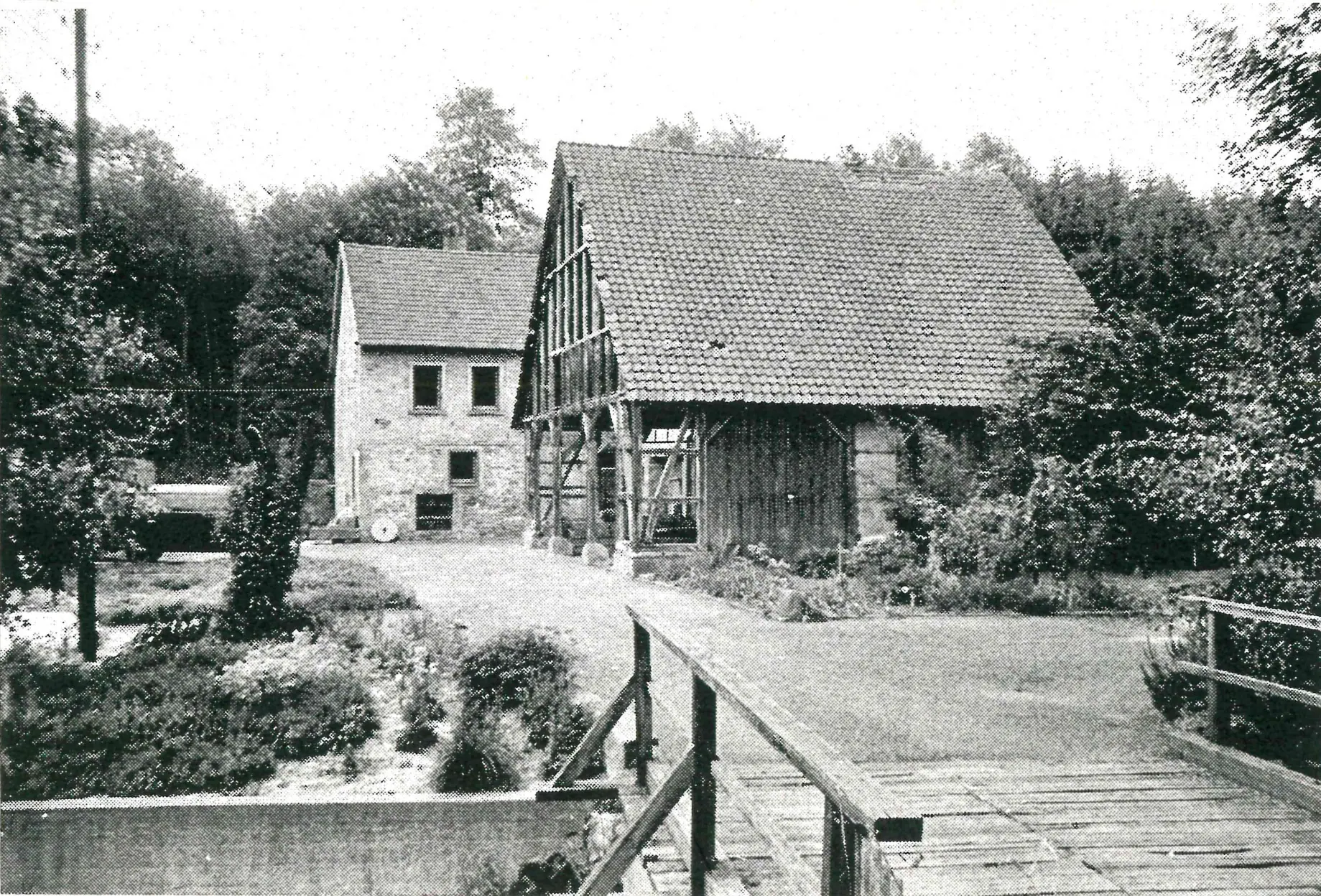 The bridge built in 1960, with the mill house and barn behind